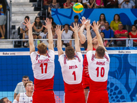 Szymon ROMAC (10), Dawid DRYJA (1) and Artur SZALPUK (17) of Poland are jumping on the net on the hit of Alexander MARKIN (10) of Russia  in...