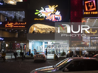 A view of an ice cream shop and fast-food restaurants in the holy city of Qom, 145Km (90 miles) south of Tehran at night amid the new corona...