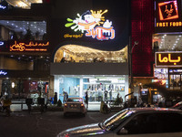 A view of an ice cream shop and fast-food restaurants in the holy city of Qom, 145Km (90 miles) south of Tehran at night amid the new corona...