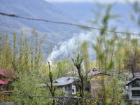 Smoke billows from a residential house where militants were believed to be trapped during cordon in Gulab Bagh area of Srinagar, Indian Admi...