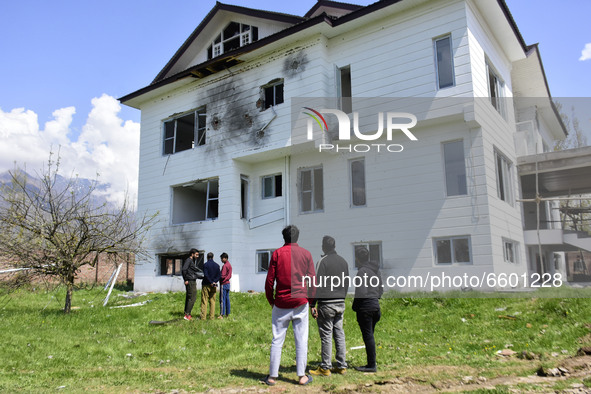 Kashmiri people access the damaged residential house where the militants were believed to be trapped during cordon in Gulab Bagh area of Sri...