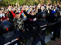 Clashes at far-right Vox rally in Madrid. Several people were injured or detained as left-wing activists clashed with police officers during...