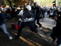  Police use batons to keep protesters away from supporters of the far-right Vox party during at Plaza de la Constitución in Vallecas neighbo...