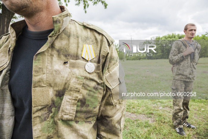 Volunteer with a medal of a battalion of the DPR army during a military training in the outskirts of Donetsk city on June 29, 2015. (Photo b...