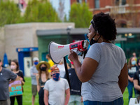An organizer speaks to the crowd as people gather at Washington Park in memorial and then march to where Timothy Thomas died 20 years ago th...