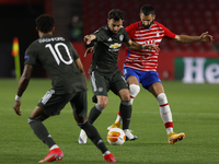 Bruno Fernandes, of Manchester United and Maxime Gonalons, of Granada CF during the UEFA Europa League Quarter Final leg one match between G...