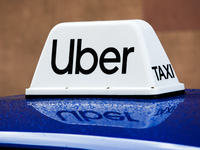 Uber Taxi sign is seen on the roof of the car in Krakow, Poland on April 7, 2021. (