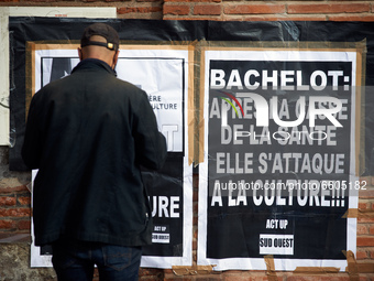 A man stands near a placard reading 'Bachelot: afte the destruction of public health, she breaks culture'. Roselyne Bachelot was Health mini...