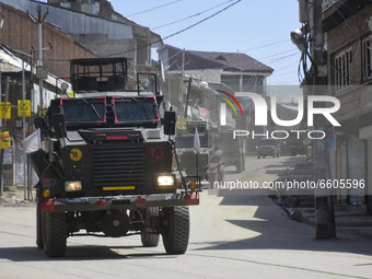 Indian forces leave from a gun battle site in Shopian district of Indian Administered Kashmir on 09 April 2021. Seven militants were killed...
