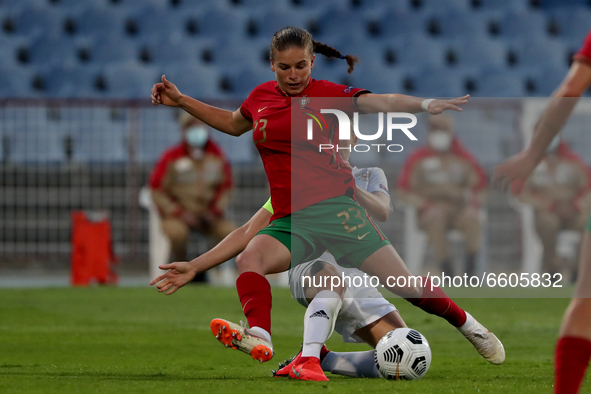 Telma Encarnacao of Portugal (top) vies with Telma Encarnacao of Russia during the UEFA Women's EURO 2022 play-off first leg match between P...