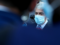 Portugal's former Prime Minister Jose Socrates wearing a face mask speaks to journalists as he leaves the court after the instructional deci...