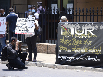 A group of protestors gathered in front of the unregulated microfinance loans in the country that has caused over 200 women to take their ow...