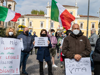 People take part in a demonstration organized by street vendors to protest against the COVID-19 restrictions on business in Brescia, Italy o...