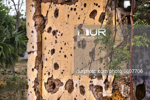 Building riddled with bullet holes during the civil war in Mugamalai, Sri Lanka. This is just one of the many reminders of the deep scars ca...