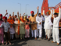 Farmers shout slogans during a 24-hour blockade of KMP Expressway (Kundli–Manesar–Palwal) as part of their ongoing protests against the thre...