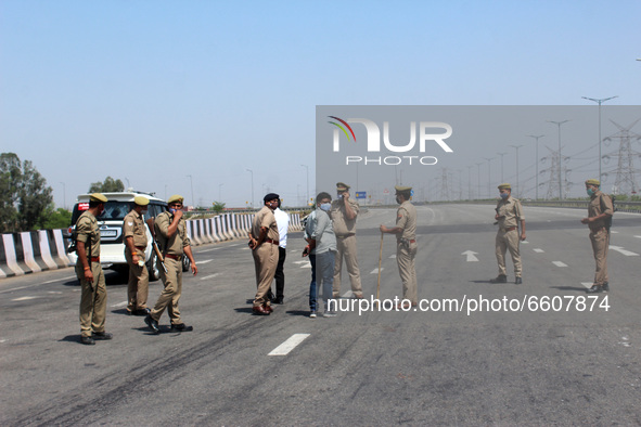 Uttar Pradesh Police personnel stand guard during a 24-hour blockade of KMP Expressway (Kundli–Manesar–Palwal) by farmers as a part of their...
