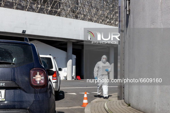 Health worker performs  the PCR Coronavirus  in a drive thru testing site at Touron Arena on April 10, 2021 in Krakow, Poland. Number of Cov...