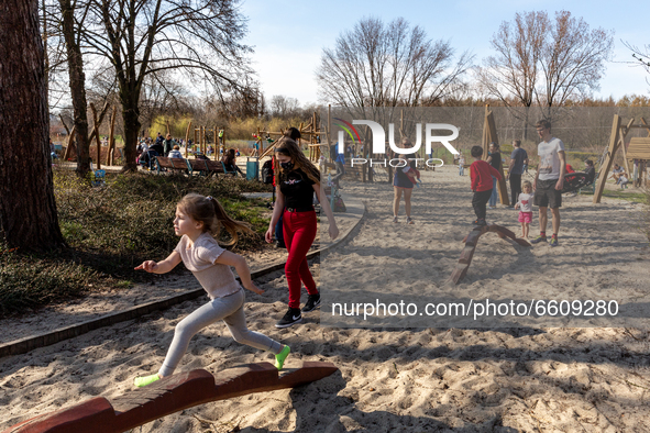 Families enjoy sunny, warm day after particularly cold period amid the third wave of Coronavirus pandemic in a public park in Krakow, Poland...