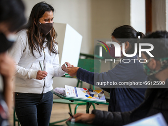 A woman during the vote in the presidential runoff election in Quito, Ecuador, on Aprl 11, 2021. Ecuadorians define the future president of...