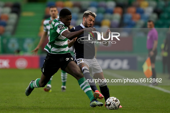 Nuno Mendes of Sporting CP (L) vies with Diogo Figueiras of FC Famalicao during the Portuguese League football match between Sporting CP and...