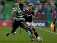Nuno Mendes of Sporting CP (L) vies with Diogo Figueiras of FC Famalicao during the Portuguese League football match between Sporting CP and...
