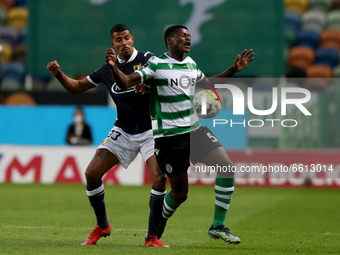 Nuno Mendes of Sporting CP (R ) vies with Anderson Oliveira of FC Famalicao during the Portuguese League football match between Sporting CP...