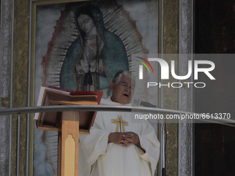 A priest officiates mass from the balcony of the Basilica of Guadalupe in Mexico City, Mexico, on April 11, 2021 during the health emergency...