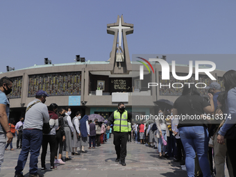 Dozens of people listen to mass on the esplanade of the Basilica of Guadalupe in Mexico City, Mexico, on April 11, 2021 during the health em...