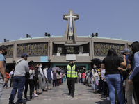 Dozens of people listen to mass on the esplanade of the Basilica of Guadalupe in Mexico City, Mexico, on April 11, 2021 during the health em...