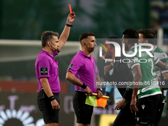 Referee Rui Costa (L) shows a red card to Sporting's head coach Ruben Amorim (C ) at the end of the Portuguese League football match between...