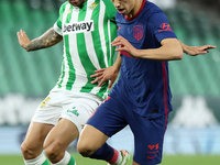Aitor Ruibal of Real Betis Balompie in action with Joao Felix of Atletico de Madrid during the La Liga Santander match between Real Betis an...