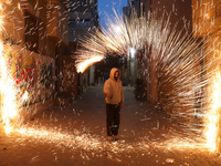 A Palestinian youth swings a homemade fireworks sparkler, as people celebrate on the night ahead of the Muslim holy fasting month of Ramadan...
