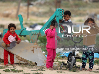Palestinian children play next to their home near the border with Israel, amid the coronavirus disease (COVID-19) outbreak, in the northern...