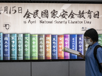 A Student walks pass a poster for the National Security Education Day, in Hong Kong, Monday, April 12, 2021. Hong Kong will host a National...