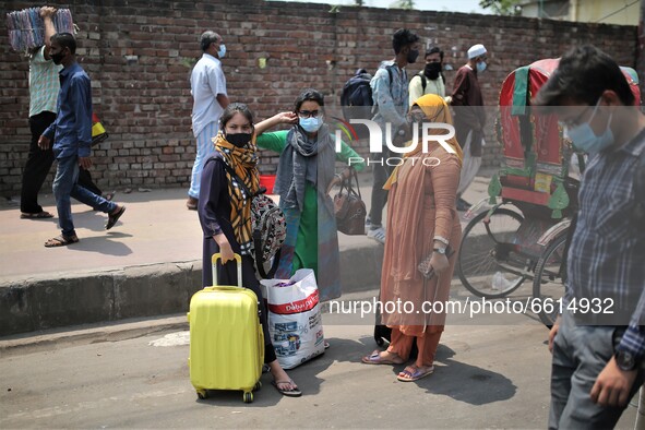 People leave the city as Bangladesh authorities ordered an eight-day lockdown to contain the spread of the Covid-19 coronavirus, in Dhaka on...