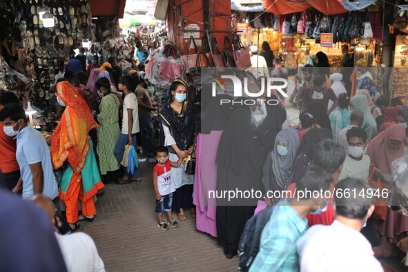 People gather at Dhaka New market for shopping as they not maintaining any kind of social distance in Dhaka, Bangladesh on April 12, 2021. 