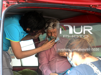 A Covid-19 patient wait inside an ambulance in front of Dhaka Medical College Hospital for treatment in Dhaka, Bangladesh, on April 12, 2021...