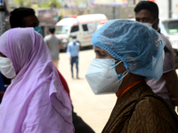 Visitors wearing face mask are seen in front of Dhaka Medical College Hospital for treatment in Dhaka, Bangladesh, on April 12, 2021.  (