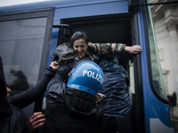  A demonstrator is being detained  during a demonstration organised by the 'IoApro' (I open) movement  against restriction measures to curb...