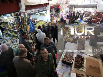 People buy food in a market on the first day of the month of Ramadan in Algiers, Algeria on April 13, 2021 Algeria experiences stability in...