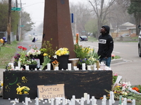 A man looks at flowers, candles, and signs at a makeshift memorial for Daunte Wright in Brooklyn Center, Minnesota, USA on April 13, 2021. (