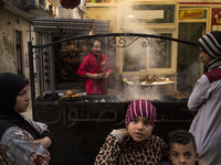 People are waiting to buy grilled meat on the first-day meal of Ramadan in Abasia on April 13, 2021, Cairo, Egypt (