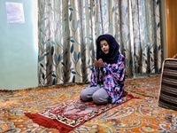 A Girl prays on the 1st day of the Holy month of Ramadan at her home amid COVID-19 Coronavirus pandemic in Sopore, District Baramulla, jammu...