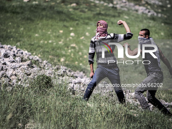 A Palestinian runs away from Israeli troops as they intervene clashes between Israeli settlers and Palestinian villagers in an area between...
