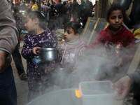 Palestinians gather to get soup offered for free during the Muslim fasting month of Ramadan, in Gaza City on April 13, 2021.
 (