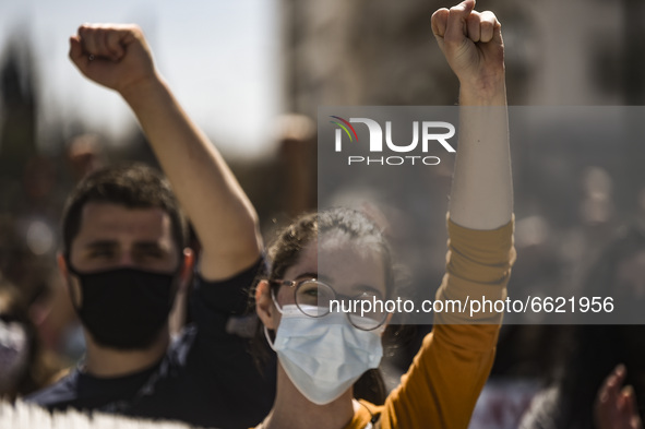 Students wearing protective face masks hold a banner during a demonstration against government plans to set up a university police, amid the...
