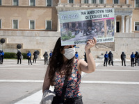 Student wearing protective face mask holds a banner during a protest against the government-promoted plan to create dedicated university pol...