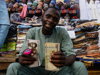A street trader display a 1000 note at the entrance of the Lagos Central Mosque (Lagos Island) located along the busy Nnamdi Azikiwe Street...