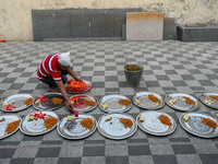 A man distributes various fruits and food to break the Iftar fast for the day during Ramadan observation at a mosque in Kolkata , India , on...