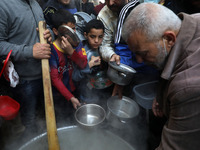 Palestinian Walid al-Hattab distributes soup to people in need during the Muslim fasting month of Ramadan in Gaza City on April 15, 2021, am...